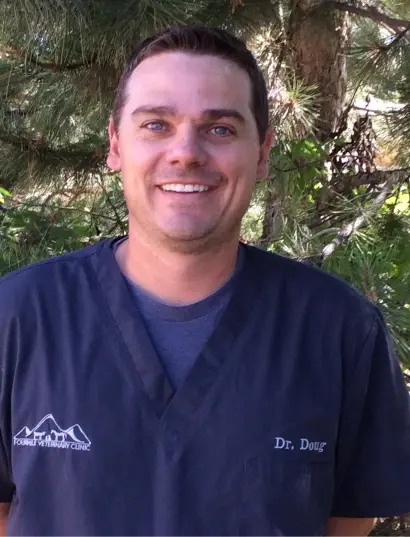 Dr. Doug smiling in dental scrubs at a Cañon City dental practice.