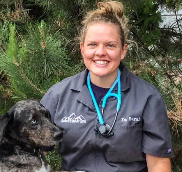 Dr. Sarah Ingram, dentist at Cañon City dental practice, smiling with dog.